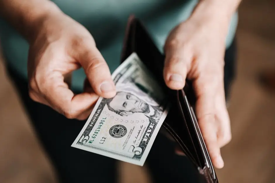 Hands counting US dollar bills for EB-5 investment